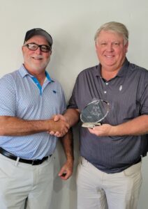 Tournament Chairman Bobby Bryant congratulates Marion Masters Seniors winner Brent Dorman